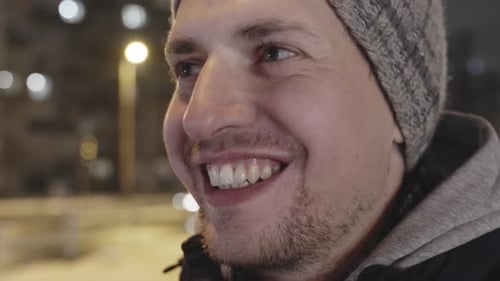 Happy positive young male with wide smile in closeup mumbling something
