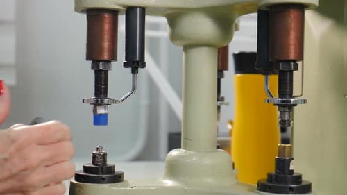 Woman Operating Riveting Machine in Factory