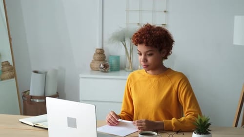 African American Girl Using Laptop at Home Office Looking at Screen Typing Chatting Reading Writing