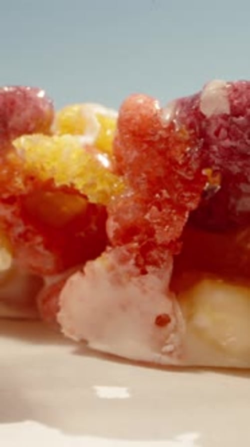 Two Snack bars of cornflakes in the form of rings, poured with milk cream, white chocolate. Vertical