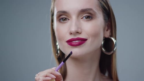 Brunette Applies Makeup With Brush, Close Up Studio Shot