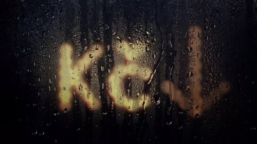 Czech Koruna sign behind rain wet window