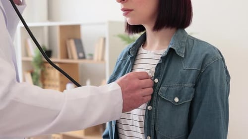 Cropped View of Physician Examining Female Patient Indoors