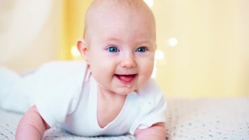 Adorable Infant Lying on Stomach, Smiling