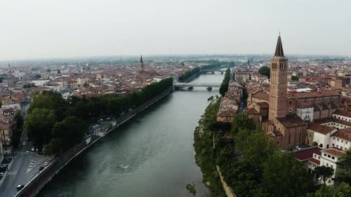 Aerial view of the Palazzo della Ragione tower overlooking the Arno River in Verona, Italy.