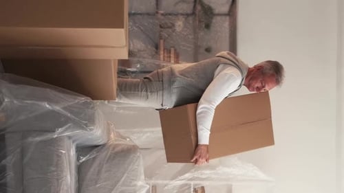 Smiling Couple Packing Up For Move