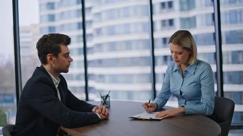 Selbstbewusster Arbeitgeber stellt Kandidaten beim Vorstellungsgespräch im Büro ein Frau unterschreibt