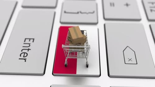 Boxes with MADE IN POLAND Text and Shopping Cart on Keyboard