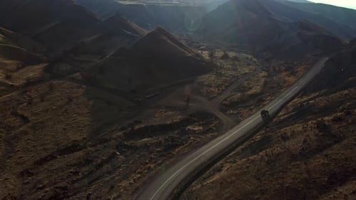 Vehicle passing the road between mountains