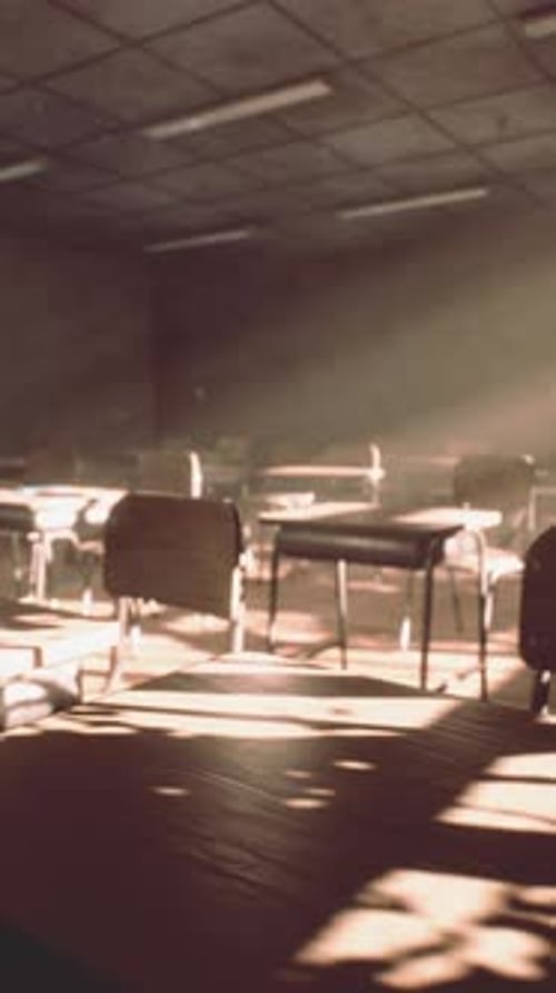 View to Classroom with Tables and Small Blackboard and Grungy Walls