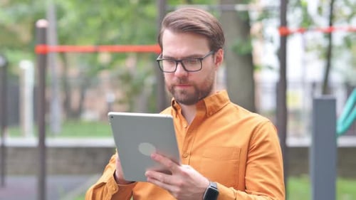 Man Using Tablet Device Outdoors