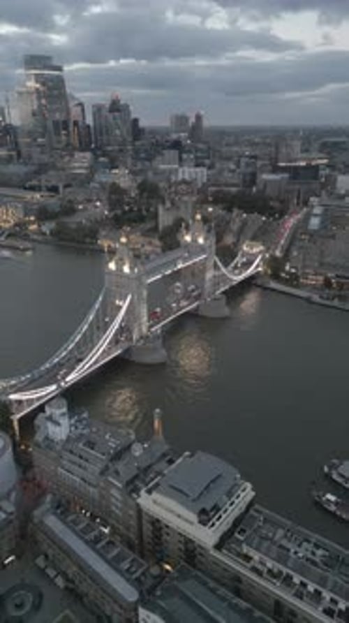 Aerial video of the city of London and the lighthouse bridge in London at night