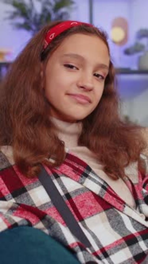 Smiling Girl Wearing Red Headband in Cozy Interior