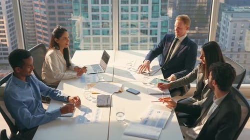 Diverse Team Discusses Business in Bright City Office