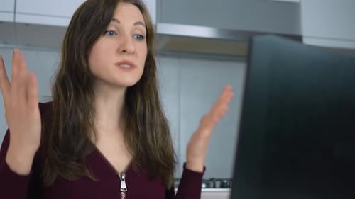 Woman Talking During Online Meeting in Home Kitchen