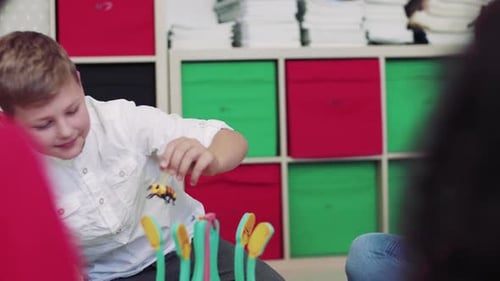 Boy Plays With Toy in Colorful Room