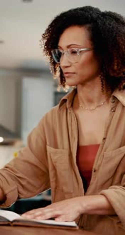 Woman Writing in Journal at Home on Table