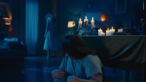 Distraught Young Woman with Ghost in a Dark Room