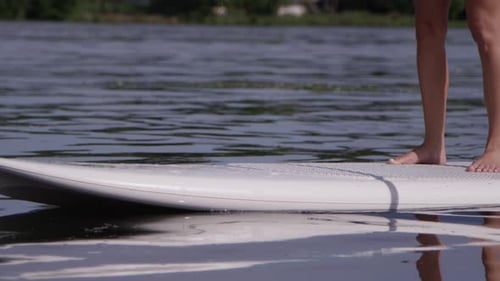 Bikini Model -Stand up paddle board close up slow motion water droplets on paddle