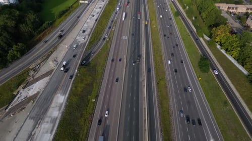 Multi-lane highway with vehicles travelling during busy daytime commute
