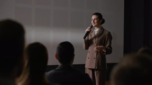 Female entrepreneur delivers motivational speech at business summit