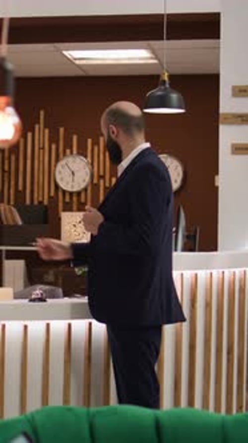 Man Checking Into Hotel, Reception Scene