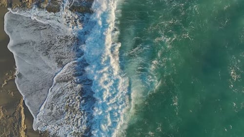Crashing Waves on Sandy Beach from Above