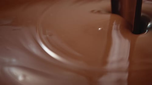Melted Chocolate Pouring and Swirling Close Up