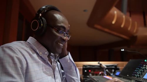 Happy Male Sound Engineer with Headphones 6064 Years