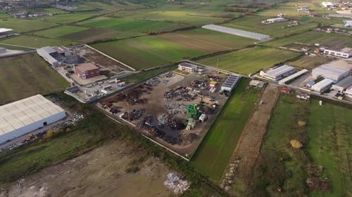 Aerial view of metal recycling plant and fields, Albania.