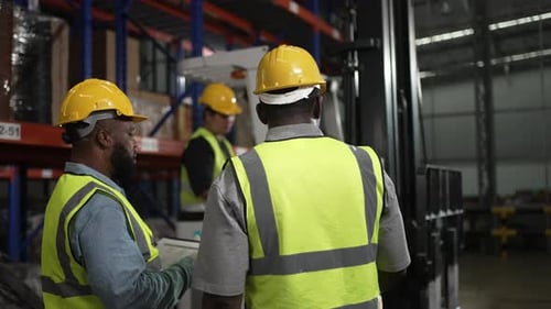 Blue collar workers working at warehouse.
