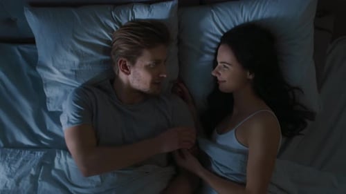 Loving Couple Relaxing in Bed at Night