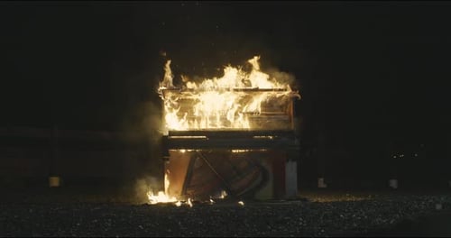 Piano Ablaze in Nighttime Urban Setting