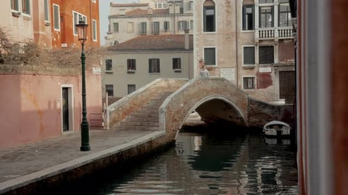 A Tourist Exploring Venice On A Bridge