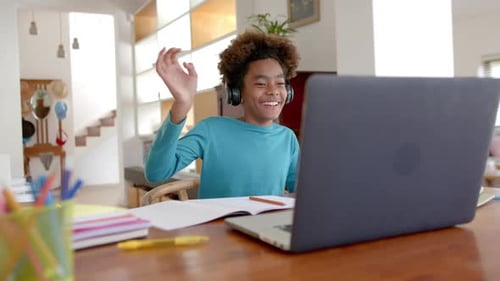 Boy Waving During Online Lesson at Home