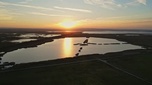 Sunset Over Serene Lake from Aerial View