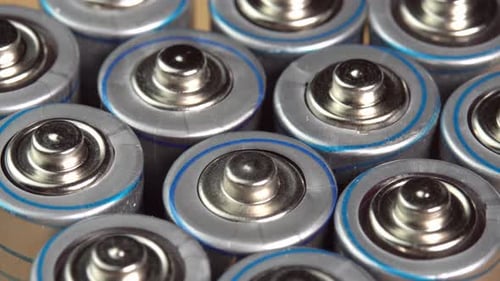 Rows of used alkaline AA batteries. Lithium ion battery pack close up. Electric power supply