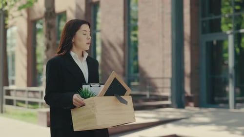 Fired Woman Walks Out of Office with Box