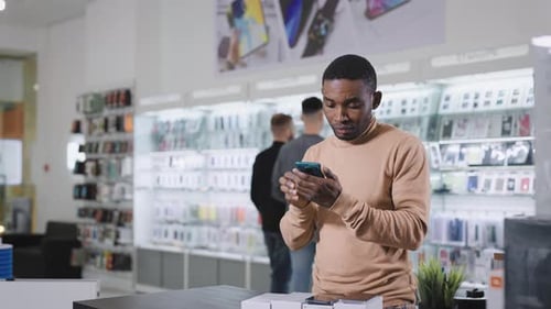 African Man in Electronics and Gadgets Department