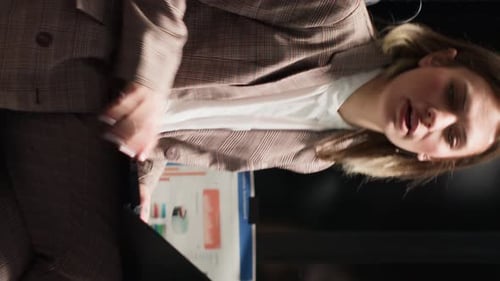 Woman Presenting from Tablet to Team