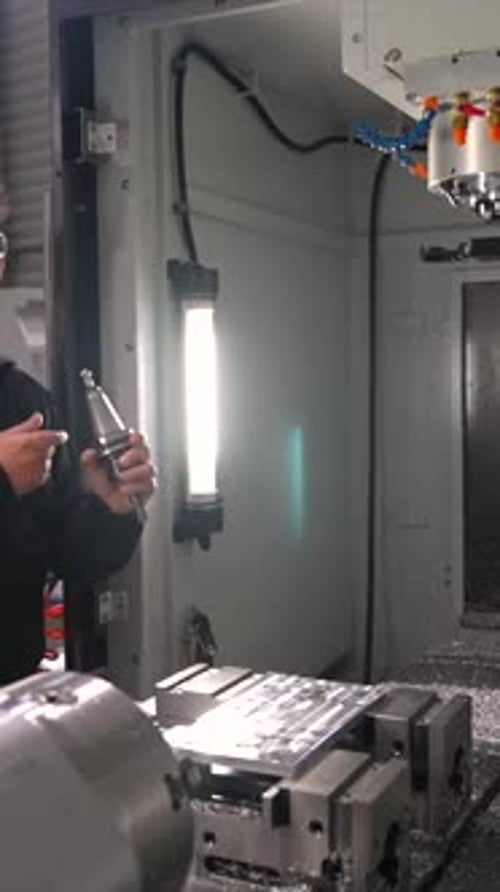 Manual Worker Placing a Lathe in the Milling Machine