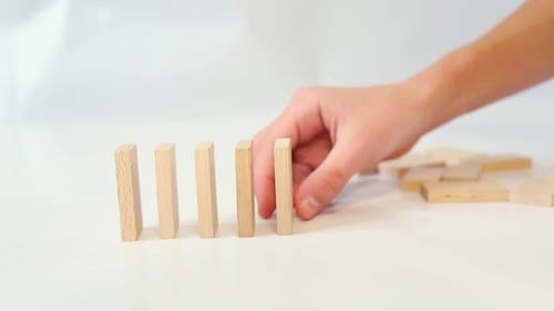 Playing with Dominoes in a Chain Reaction The Boy Builds Wooden Dominoes Ina Row