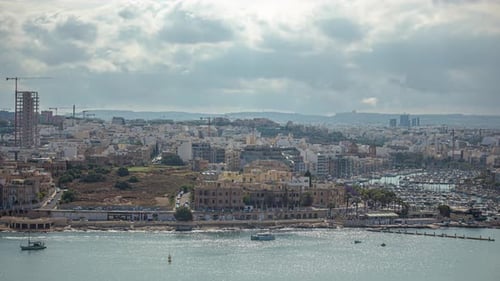 A Large Cityscape At The Coast And White Boats Sailing In The Sea In Malta