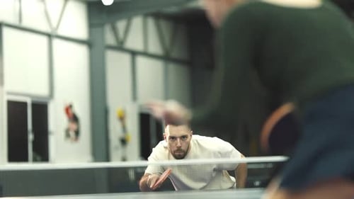 Focused Man Playing Intense Table Tennis Game