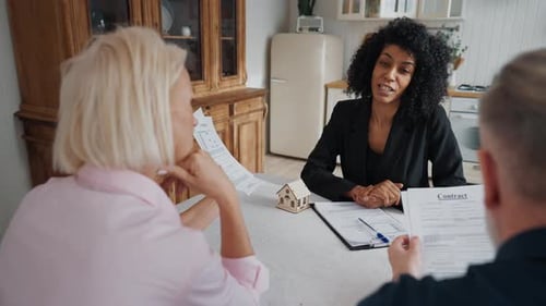 Discussion About Real Estate Deal Mature Spouses Consultation with Female Agent Charming African