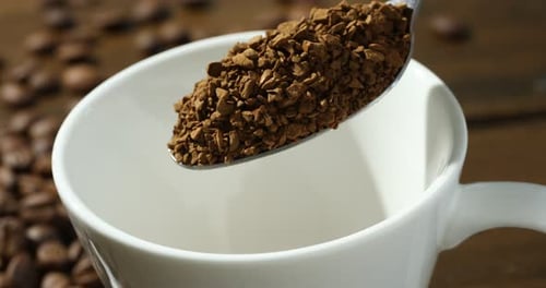 Instant Coffee Being Poured Into A Mug