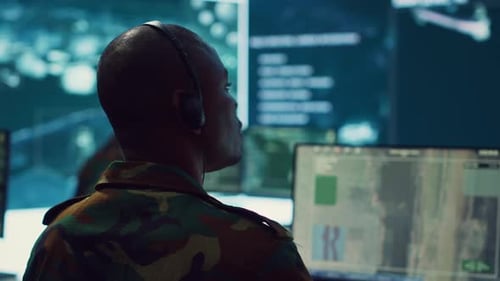 Soldier Working at Computer Station in a Control Center