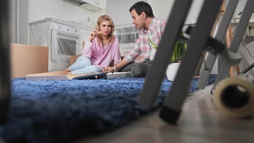 Couple Eating Pizza Together on a Blue Carpet