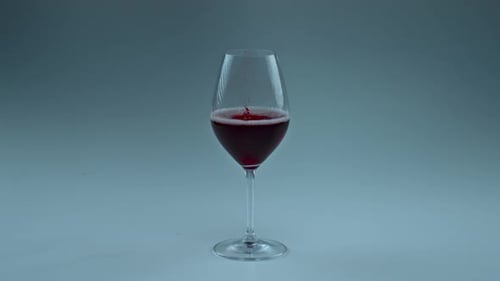 Wine Glass being Filled with Red Wine