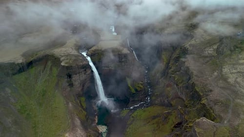 Experience the Majesty of Haifoss Waterfall in Iceland Surrounded By Rugged Landscapes and Mist